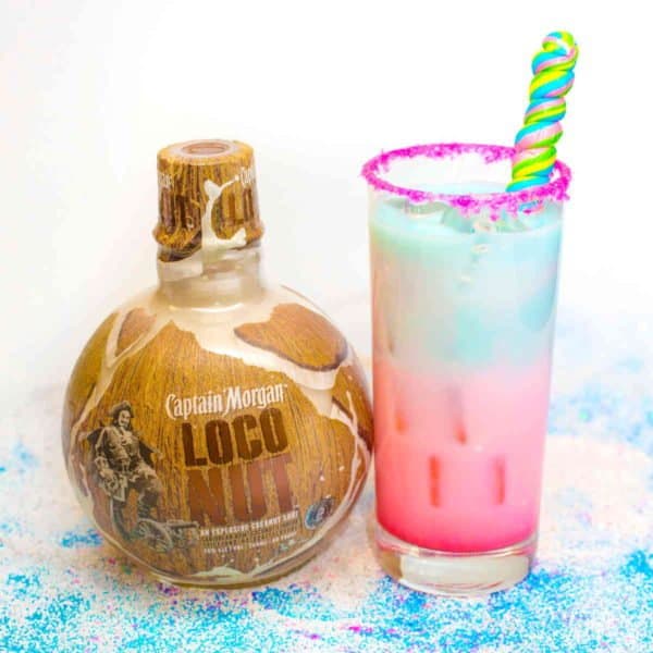 Loco Unicorn cocktail beside bottle of Captain Morgan Loco Nut