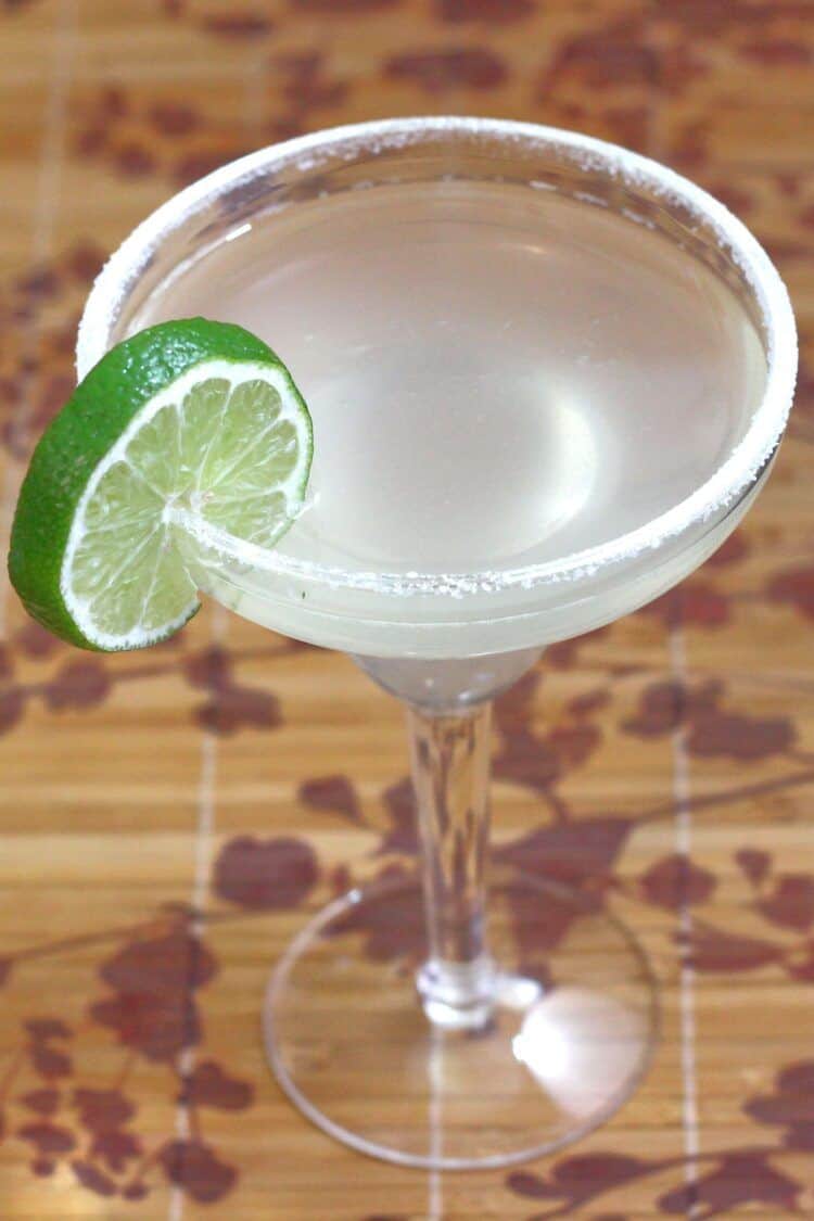 Margarita drink with salt rim and lime wheel