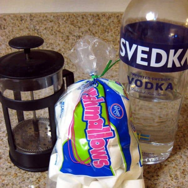 Bag of marshmallows next to French press and vodka bottle