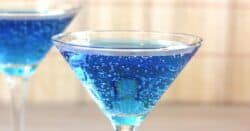 Blue bubbly cocktail in martini glass