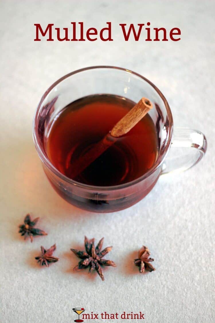 Mulled wine in glass mug with cinnamon stick