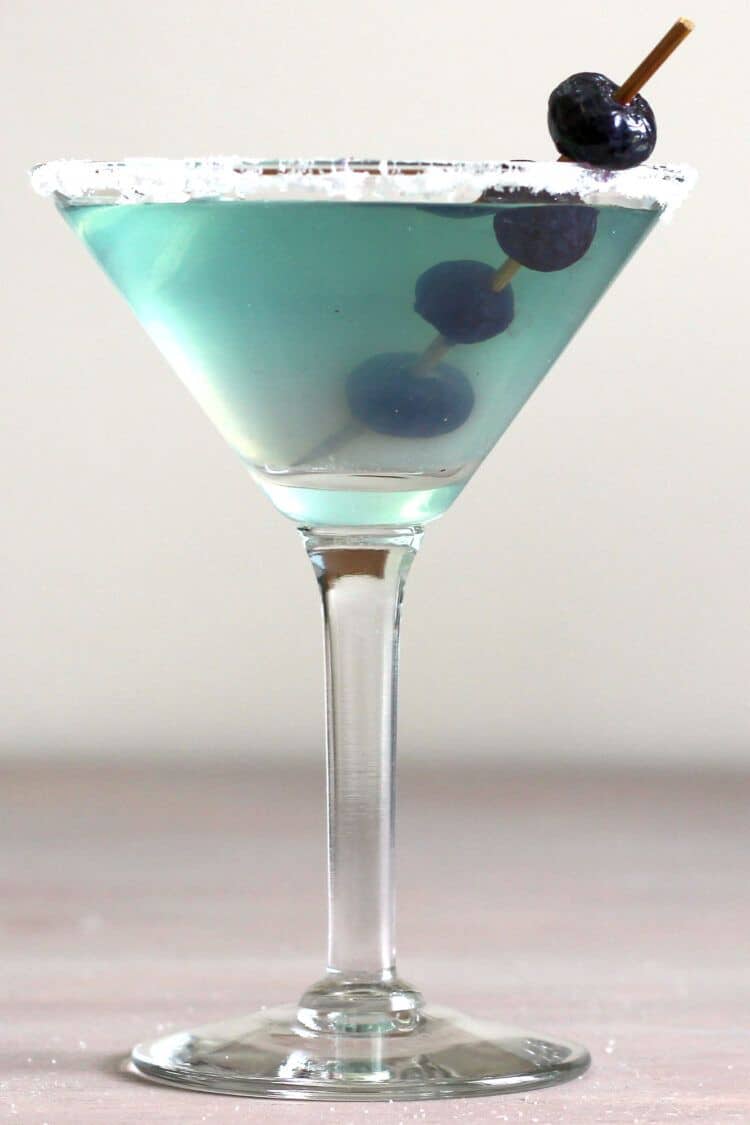 Beautiful blue-green Neato Bandito drink with speared blueberry garnish