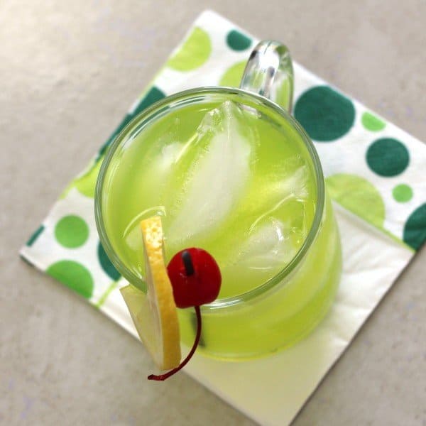 Overhead view of Neon Tea cocktail with lemon and cherry