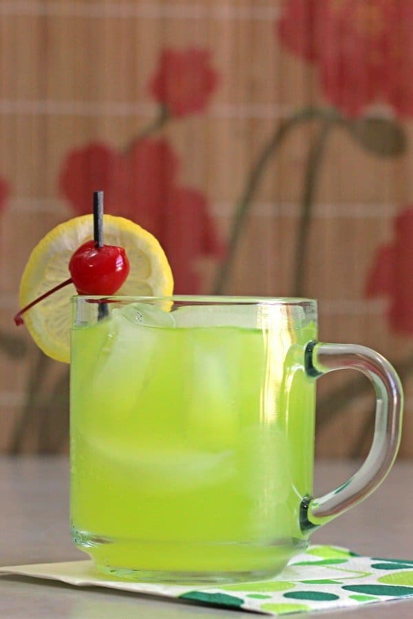 Neon Tea cocktail with lemon and cherry