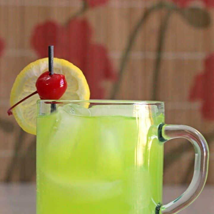 Neon Tea cocktail with lemon and cherry