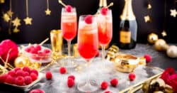 New Years Cocktails with raspberry garnish on table with holiday decorations