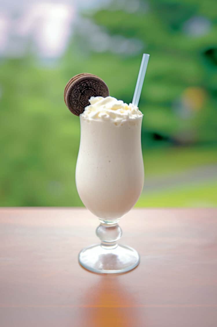 Pensacola Bushwacker drink in parfait glass with cookie garnish