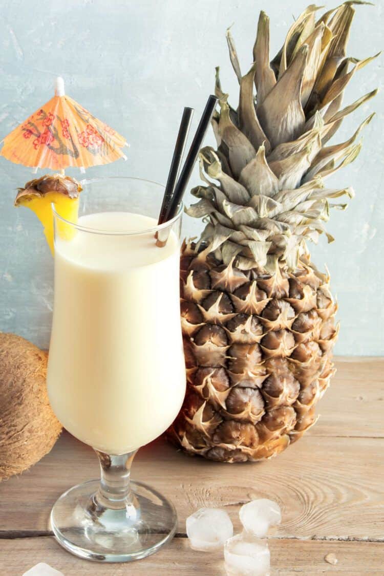 Pina Colada drink in front of coconut and pineapple