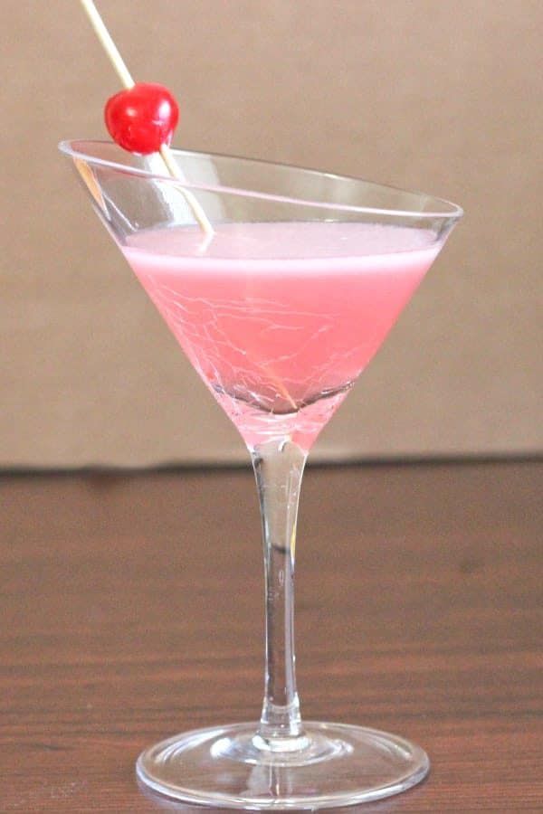 Pink Lady cocktail on table in martini glass