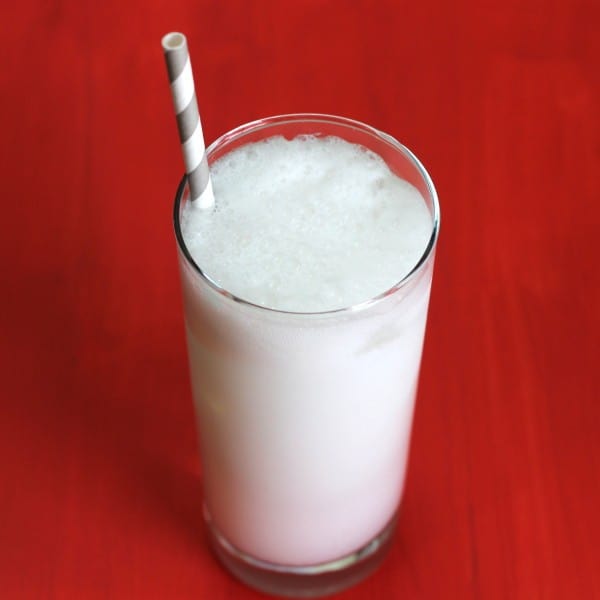 Overhead view of Pink Rose Fizz drink with paper straw