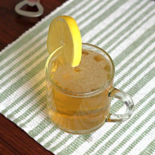 Porch Crawler drink with lemon slice on green striped placemat