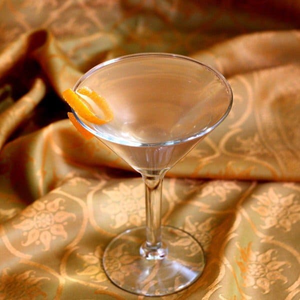 Angled view of Prohibition cocktail with orange twist