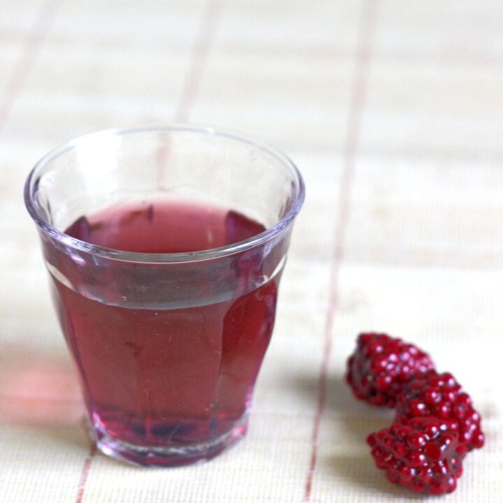 Purple Hooter Shooter on table with raspberries