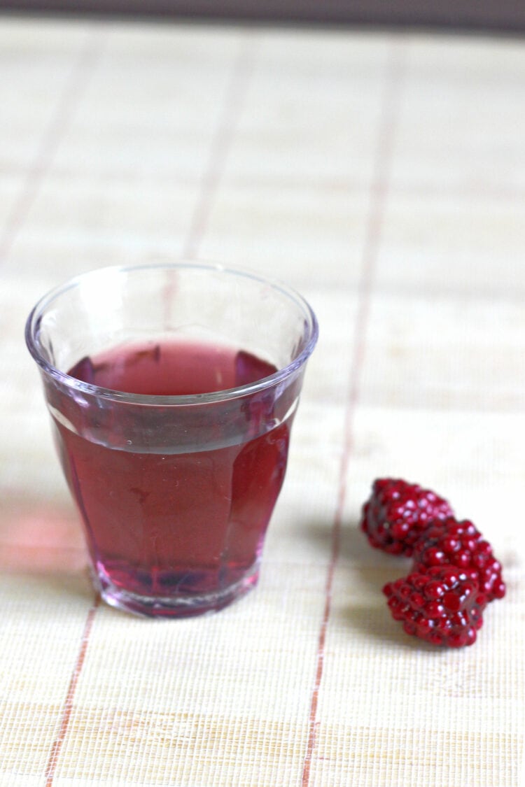 Purple Hooter Shooter on table with raspberries