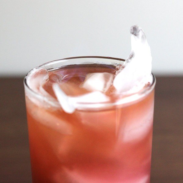 Closeup of ice floating in Purple Pushover drink