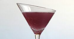 Close-up view of Purple Turtle drink in decorative martini glass