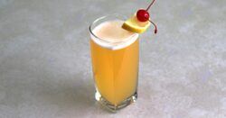 Quantum Theory drink with cherry and lemon wedge