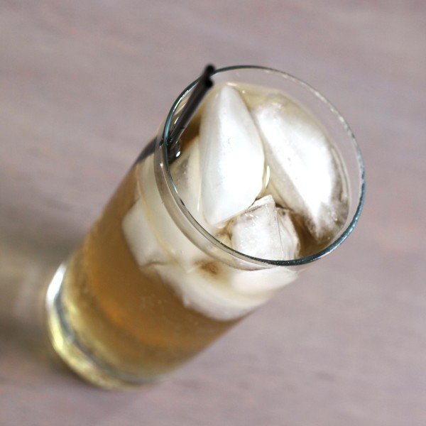 Tilted angle view of Queen Soda drink in tall glass with ice