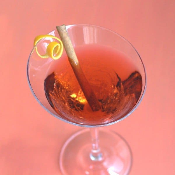 Overhead view of Queen Victoria cocktail with lemon twist and cinnamon stick