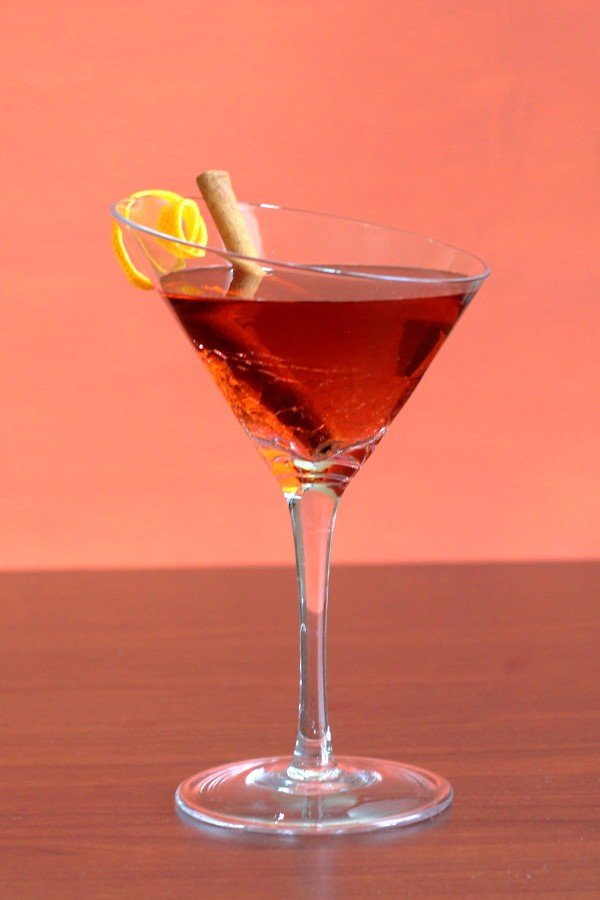 Queen Victoria cocktail with lemon twist and cinnamon stick