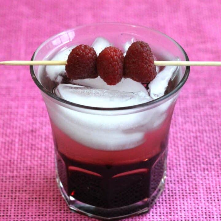 Raspberry Kamikaze drink with speared raspberries