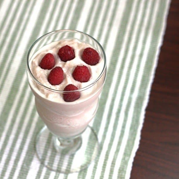 Overhead view of Raspberry White Chocolate Cheesecake drink with raspberries floating on top
