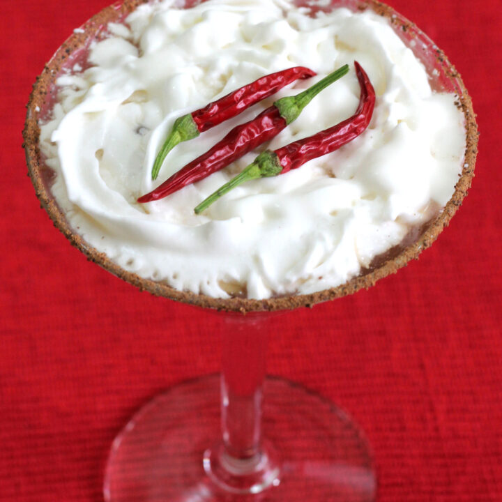 Red Hot Santa Tini with whipped cream and a chili powder cocoa rim