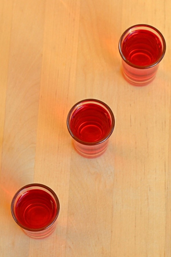 Overhead view of Red Hot Shot drinks lined up on bar