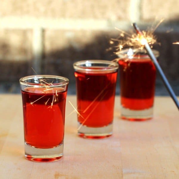 Red Hot Shot drinks lined up on bar with sparkler