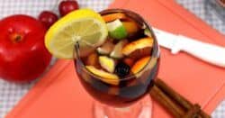 Sangria drink on cutting board with fruit