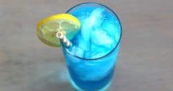 Overhead view of bight blue Sex in the Driveway drink with lemon