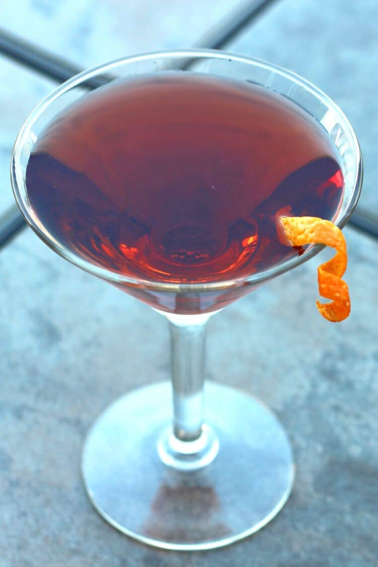 Cocktail featuring sloe gin on table