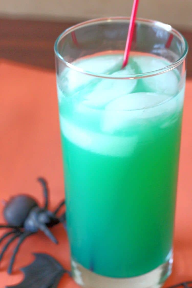 Green Spooky Juice drink against orange backdrop