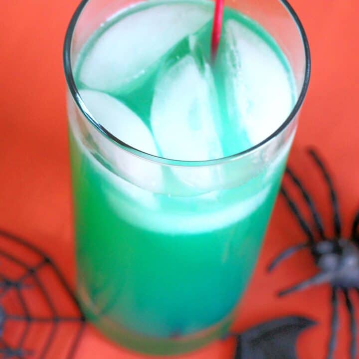 Green Spooky Juice drink against orange backdrop