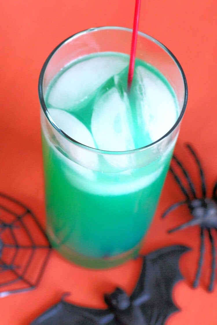 Green Spooky Juice drink against orange backdrop