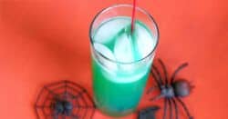 Green Spooky Juice drink against orange backdrop