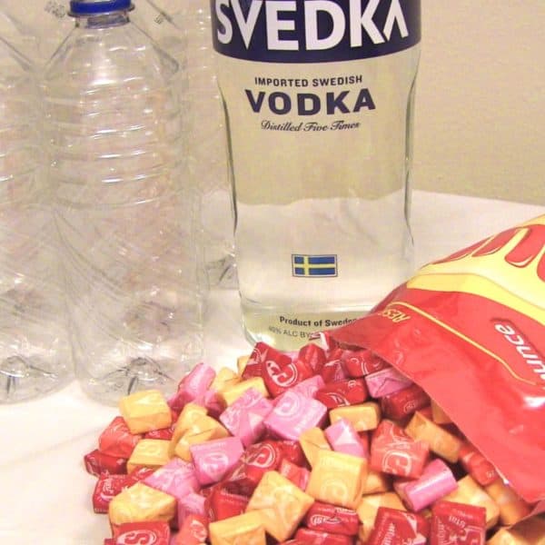 Bottle of vodka, bag of Starbursts, and several empty plastic water bottles