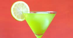 A green Super Bowl drink with lime garnish