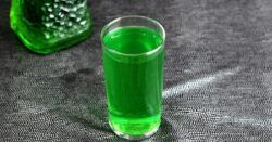 Sweet Tart drink in front of bottle of Midori