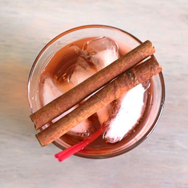 Overhead view of Thanksgiving Cider cocktail with cinnamon sticks