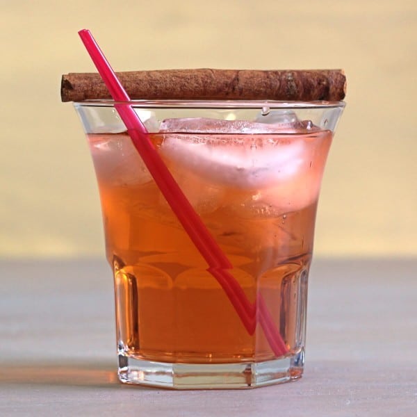 Thanksgiving Cider cocktail with cinnamon sticks and red straws