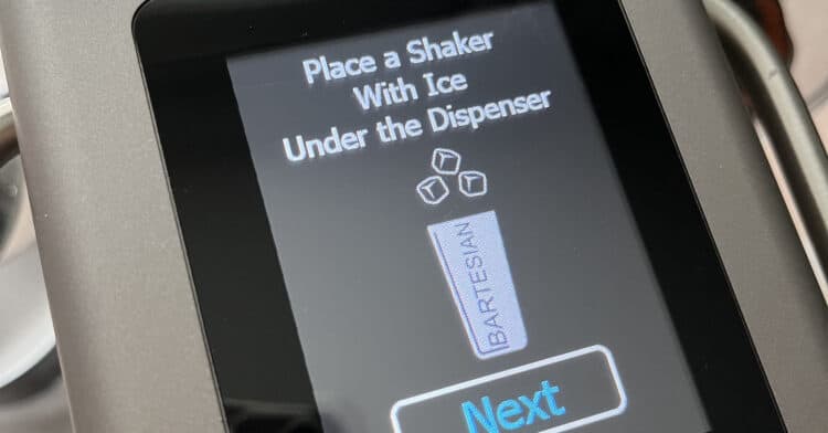 Bartesian touch screen saying to place a shaker with ice under the dispenser