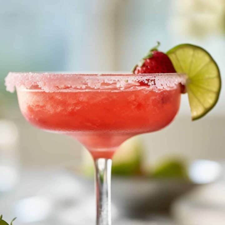Triple Berry Margarita drink with lime wheel