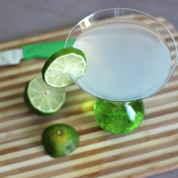 Overhead view of Tropical Rum drink on cutting board with limes
