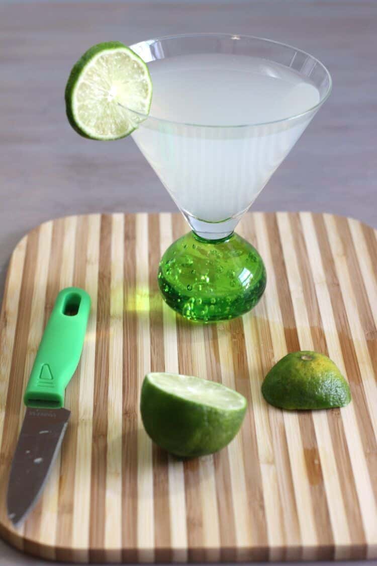 Tropical Rum drink on cutting board with limes