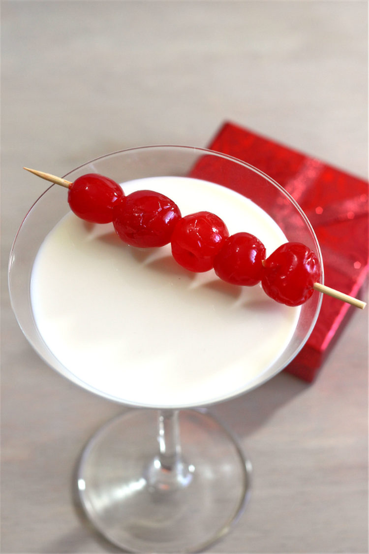 Angled view of Very Cherry Christmas drink with speared cherries