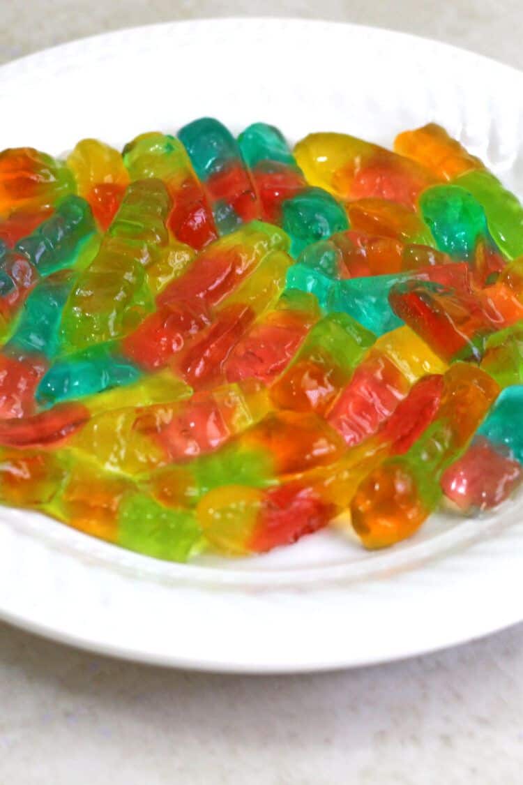 Vodka gummy worms on a white plate