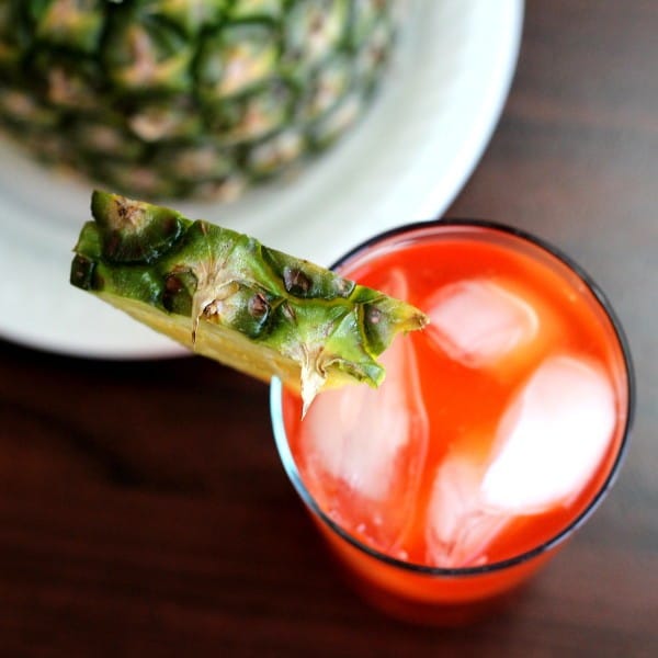 Overhead view of Western Sling drink next to pineapple on plate