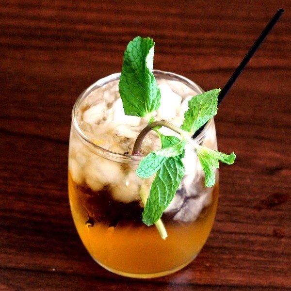 Whiskey Smash drink with mint sprigs