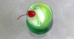 Overhead view of bright green Zolezzi Cocktail with cherry